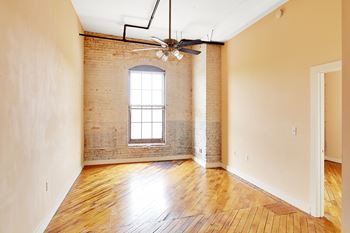 A room with a window and a ceiling fan. at Nantucket Lofts Apartments, Kinston, North Carolina